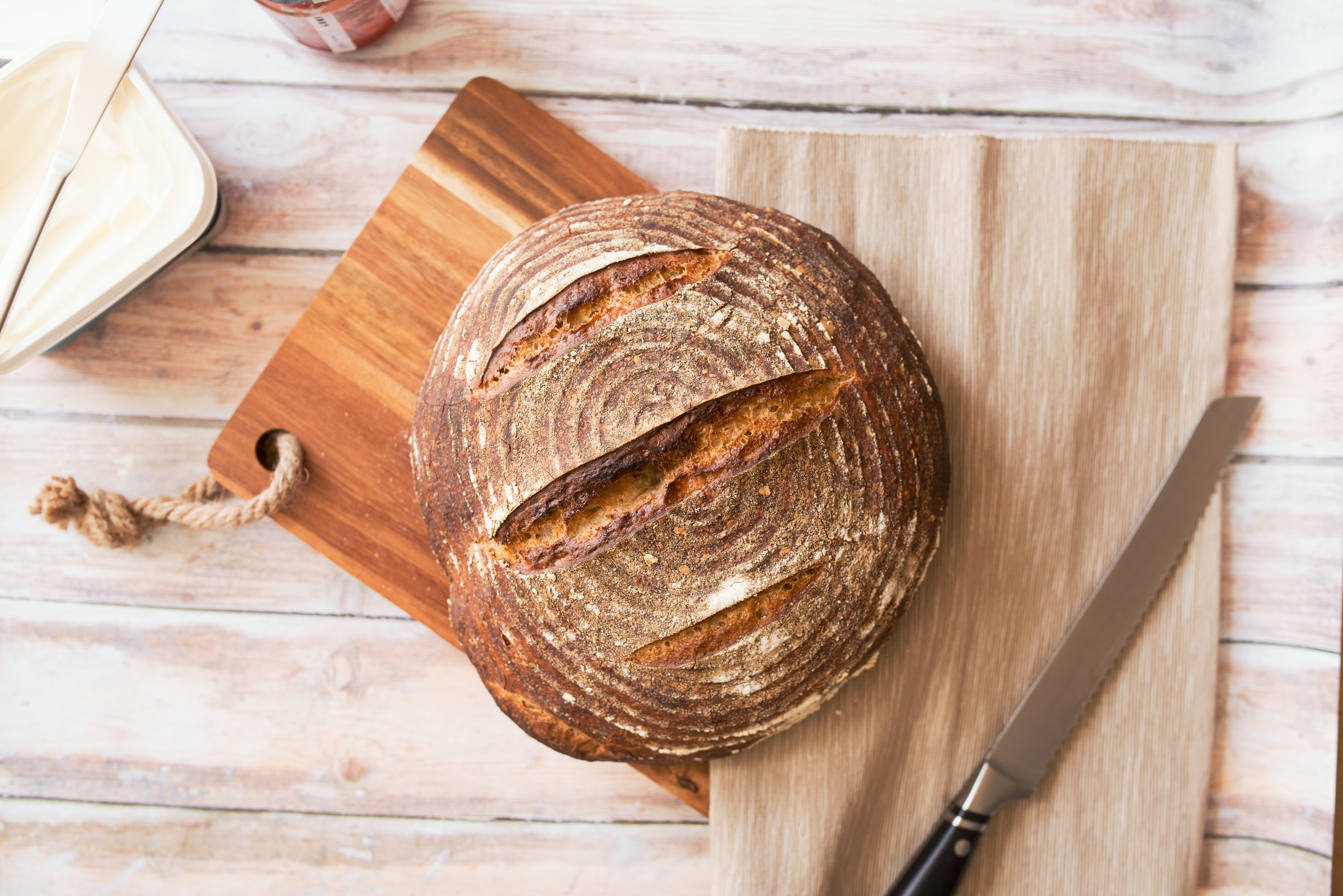 A loaf of sourdough bread on a cutting board